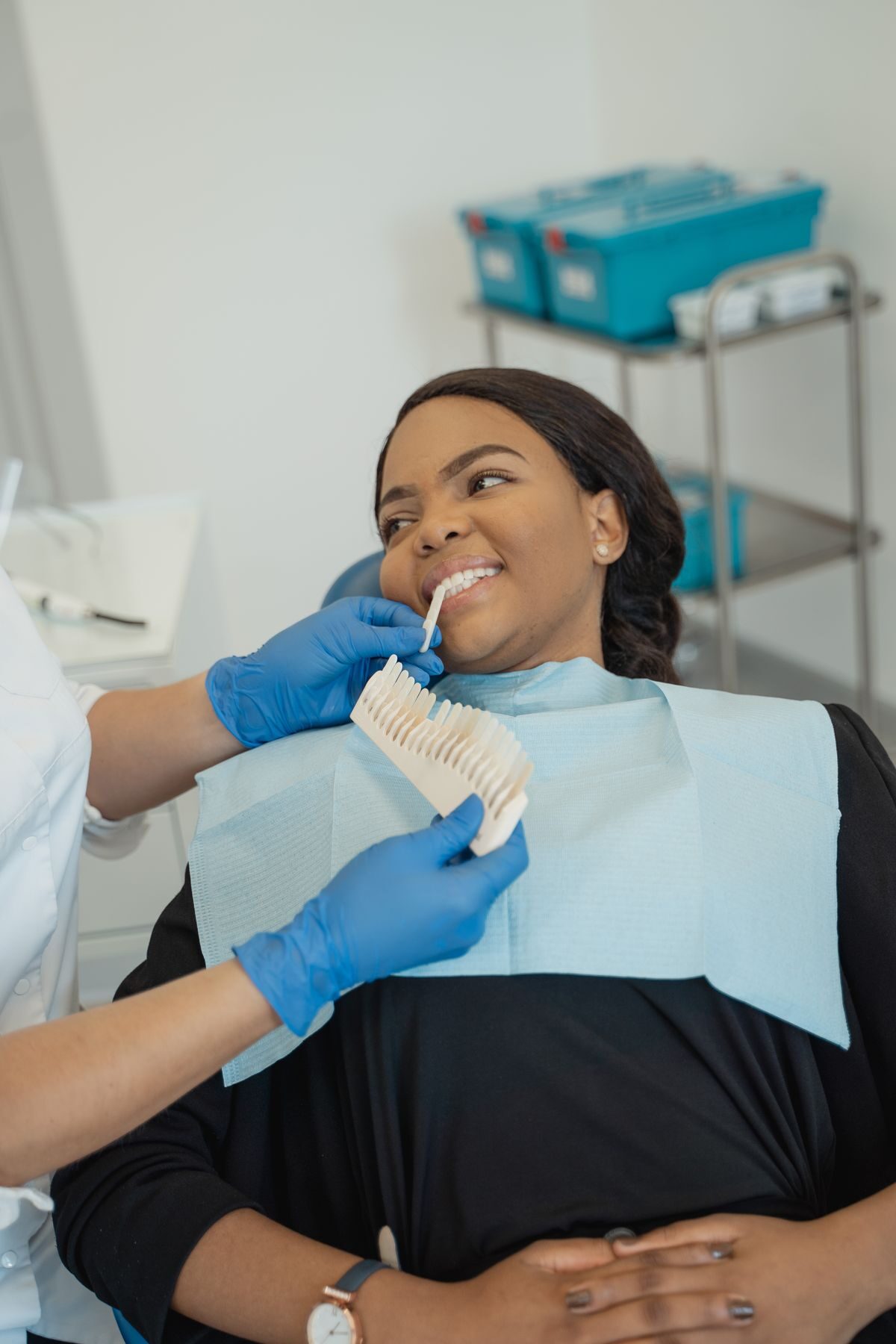 Dentist comparing a natural smile shade with a patient